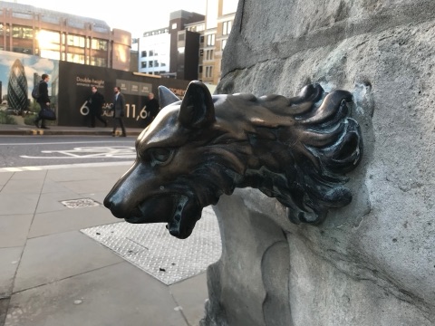 The brass wolf's head spout on the stone Aldgate Pump