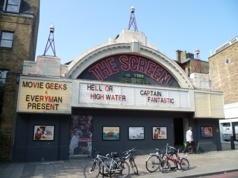 The Screen on the Green cinema on Islington Green: a curved white front under a red neon sign, with the week's films on the letterboard