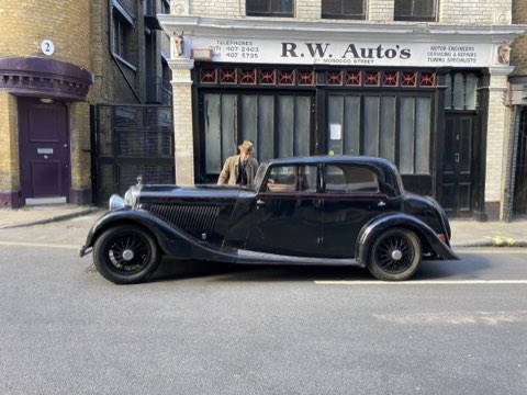 A black pre-war saloon parked outside R.W. Auto's, an old garage front near Bermondsey Street