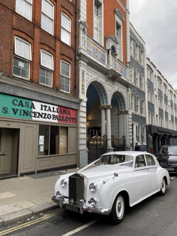 A white vintage Rolls-Royce outside St Peter's Italian Church on Clerkenwell Road, beside the Casa Italiana