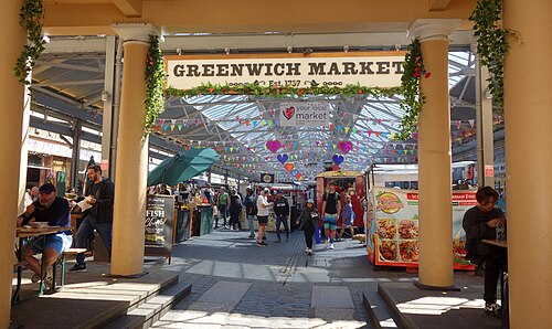Greenwich Market under its roof: stalls and shoppers along the covered lanes