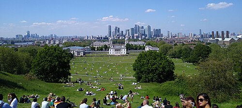 The view from the Royal Observatory: the lawns of Greenwich Park, the Queen's House and the Old Royal Naval College, with the towers of Canary Wharf behind