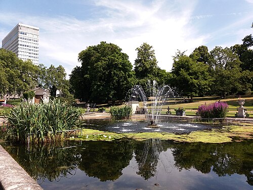 The Italian Gardens in Kensington Gardens: a stone basin and fountain among clipped planting, with trees behind
