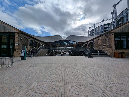 Coal Drops Yard: two Victorian coal warehouses joined by the curved kissing roofs of 2018, seen from the north