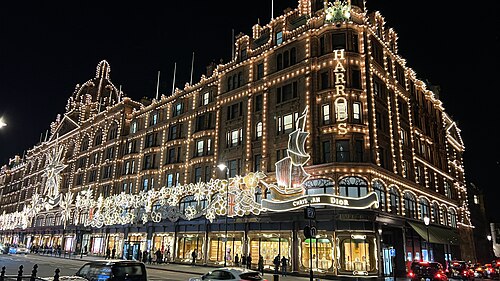 Harrods lit up at night under its Christmas decorations