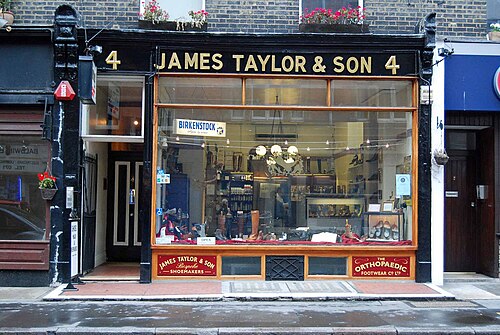 The old shopfront of James Taylor & Son, bootmakers, with its gilt lettering on Marylebone High Street
