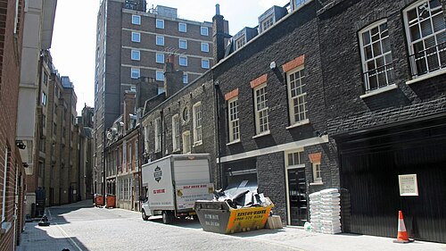 A cobbled Georgian mews in Mayfair, with painted garage doors and window boxes
