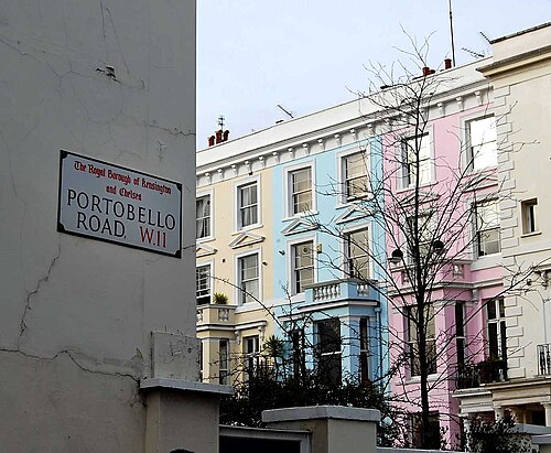 Pastel-painted terraced houses along Portobello Road in Notting Hill, in pink, blue and yellow