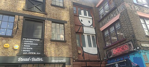 A Stik figure painted on the corner of a brick building in Rivington Street, Shoreditch