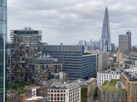Southwark rooftops from above, Neo Bankside's braced blocks in front and the Shard behind
