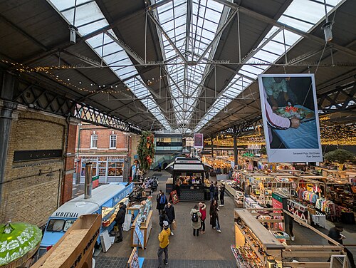 Inside Old Spitalfields Market: stalls under the Victorian roof