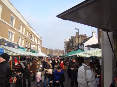 Stalls and crowds down Broadway Market towards London Fields