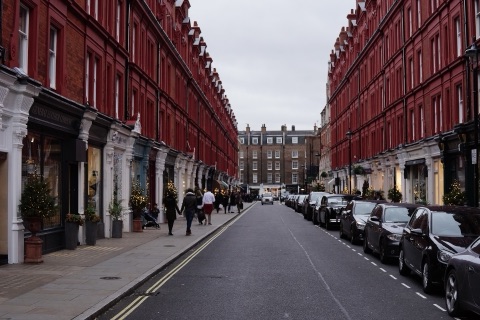 Chiltern Street's red brick terraces, cars parked along both sides