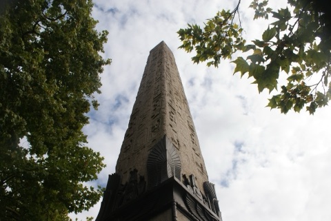 Cleopatra's Needle from below, the obelisk rising through plane trees on the Embankment