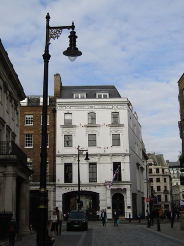 The frontage of Gieves & Hawkes at No. 1 Savile Row, with its bow windows and royal warrants