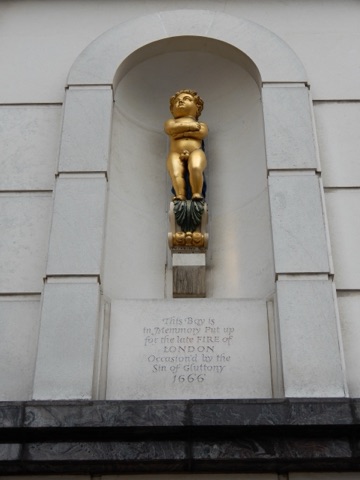 The small gilded figure of the Golden Boy of Pye Corner in his niche on Cock Lane