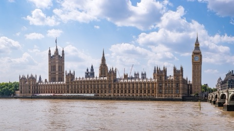 The Palace of Westminster along the Thames, the Victoria Tower at one end and the Elizabeth Tower at the other, with Westminster Bridge beyond