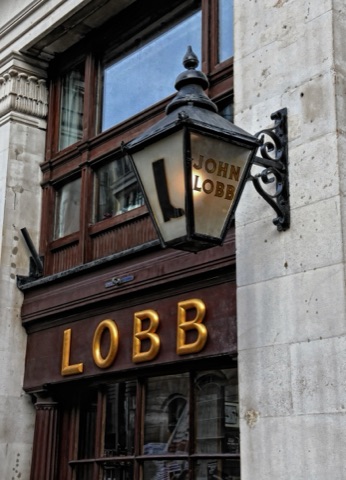 The shopfront of John Lobb bootmaker on St James's Street, with wooden shoe lasts displayed in the window