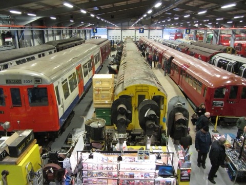 Rows of old Underground carriages and buses stored in a hangar at the Acton depot