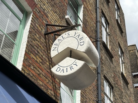 The hanging sign of Neal's Yard Dairy