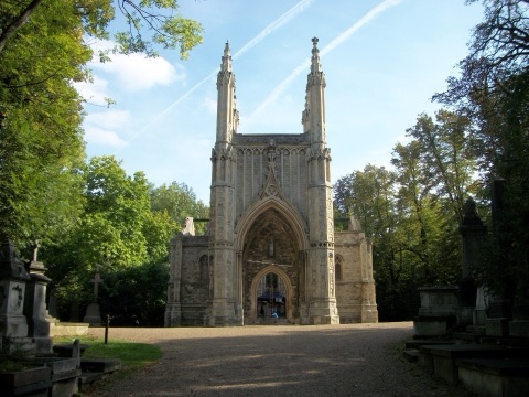 The ruined Gothic Anglican chapel at Nunhead Cemetery, headstones and trees around it