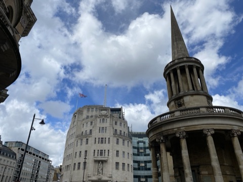 Broadcasting House's curved white front behind the round portico and spire of All Souls Langham Place