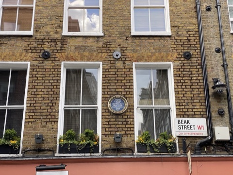 A blue plaque to Canaletto on the brick front of 41 Beak Street, below the street sign