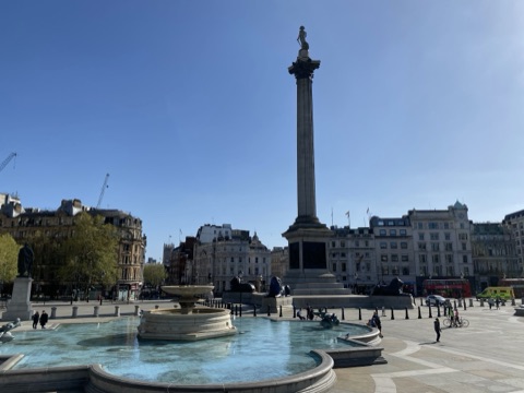 Nelson's Column above Trafalgar Square's fountains on a clear day