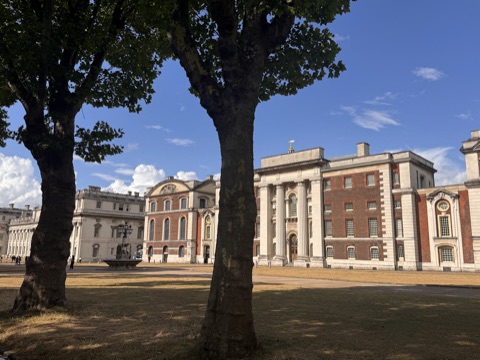The Old Royal Naval College's colonnades and courts from the lawn, between plane trees