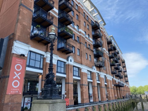 Oxo Tower Wharf's brick riverside front with balconies, an OXO banner at the corner