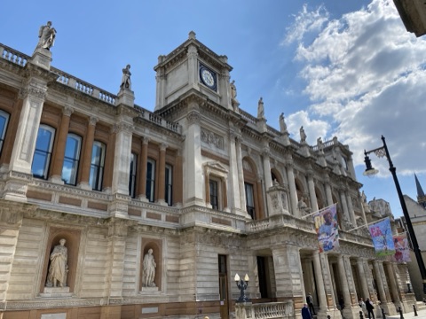 Burlington House's facade, statues standing in niches along the first floor
