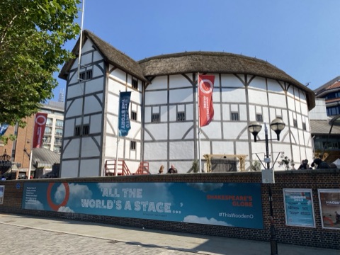 Shakespeare's Globe on Bankside: a round theatre of white walls and black timbers under a thatched roof