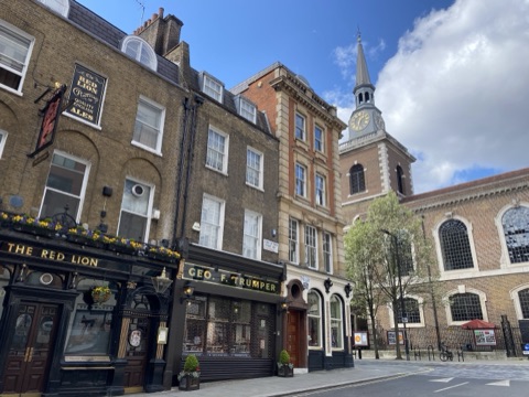 Duke of York Street towards St James's Piccadilly, the Red Lion and a barber's shopfront in front of the church tower