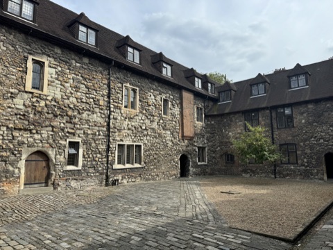 A cobbled courtyard inside the Charterhouse, stone ranges with dormer windows