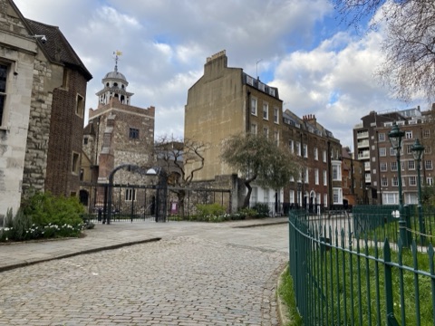 Charterhouse Square's cobbles looking towards the gatehouse and its clock turret
