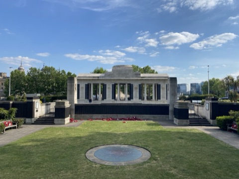 The Tower Hill Memorial's colonnade behind a lawn, wreaths along the panels