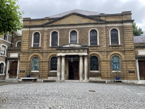 Wesley's Chapel's brick front, a portico between round-headed windows