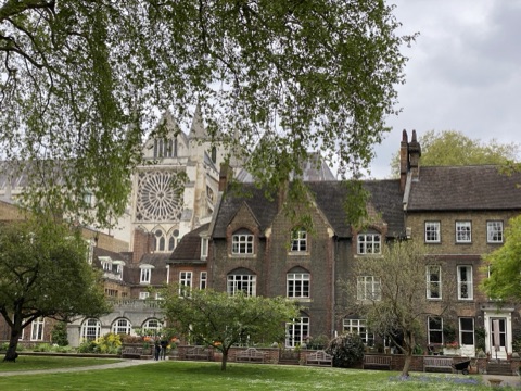 The Abbey gardens, a brick range in front and the transept's rose window behind