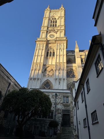 One of Westminster Abbey's west towers in low sun, seen from the lane below