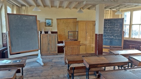 The Victorian classroom at the Ragged School Museum, wooden desks facing a blackboard