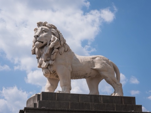 The South Bank Lion, a Coade stone sculpture at the eastern end of Westminster Bridge, Lambeth, London, England. Side view showing the whole animal on its granite plinth