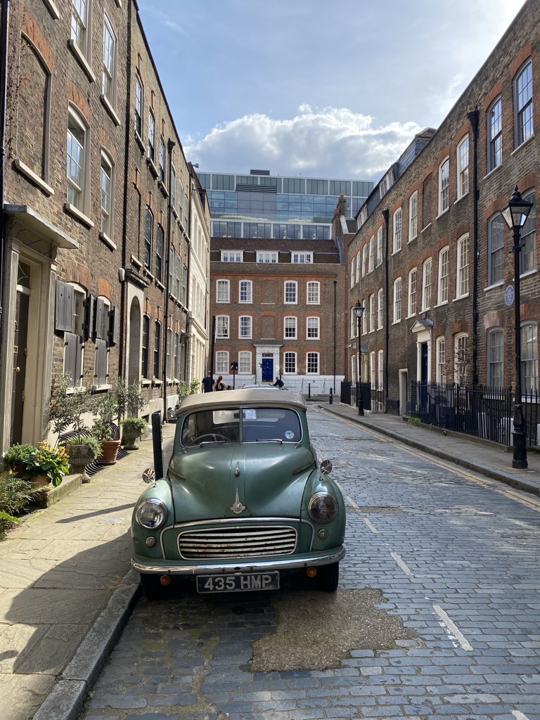 A Morris Minor parked on the cobbles of Elder Street, between Georgian brick terraces