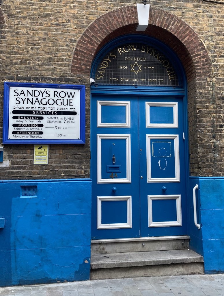 A blue arched door under a fanlight lettered Sandys Row Synagogue, founded 1854