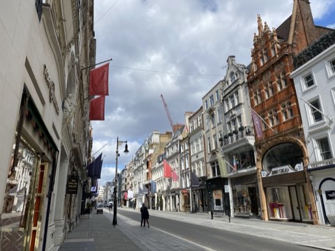 New Bond Street by day, banners along the shopfronts and the street empty of traffic