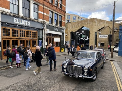 Park Street by Borough Market, Elliot's and Bao on the left and the Borough Yards frontage ahead, a classic saloon parked at the kerb