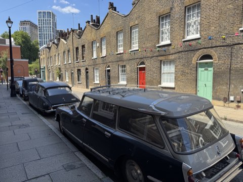 Roupell Street's unbroken terrace of 1820s brick cottages with classic Citroëns parked outside