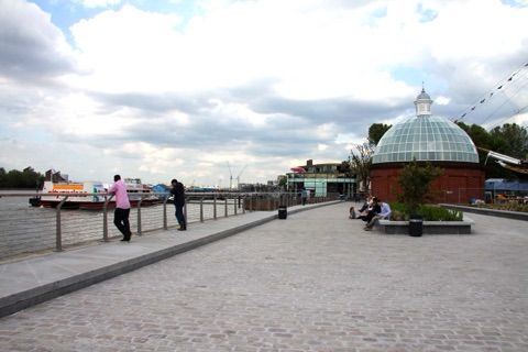 The paved riverside path at Greenwich, with the domed entrance to the foot tunnel